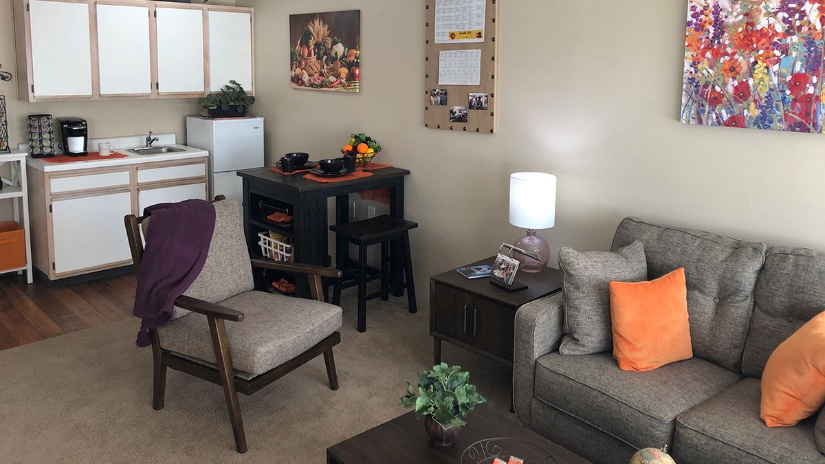 A cozy living room with modern furniture and warm decor.