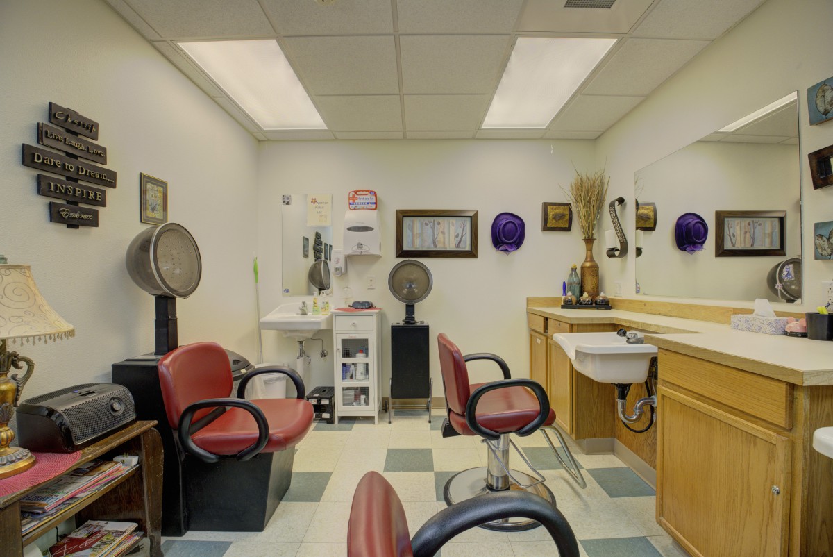 A cozy salon interior with styling chairs and equipment.