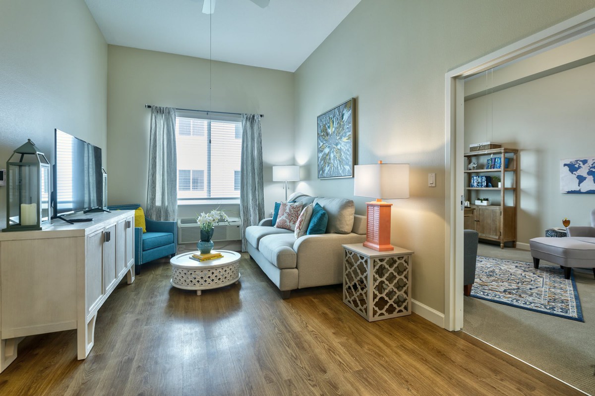 A cozy living room with modern furnishings and bright lighting.