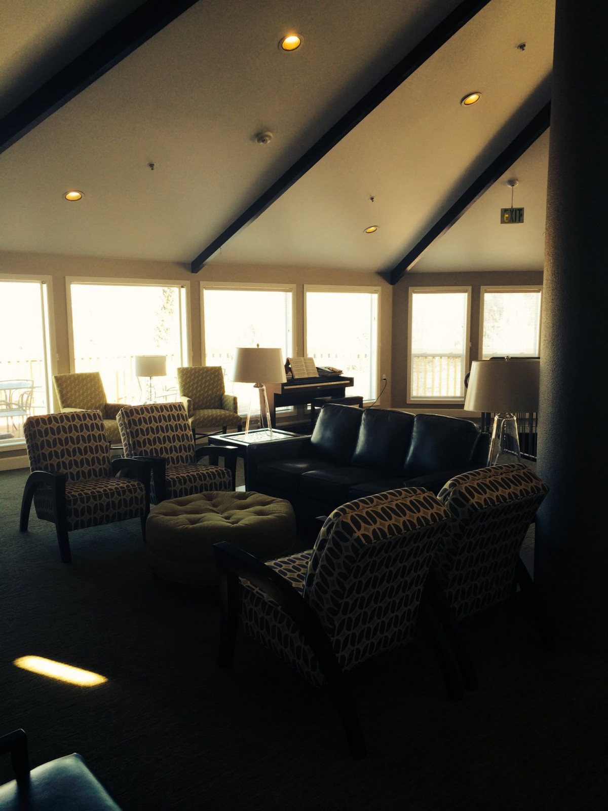 A cozy living room with ample seating and large windows allowing natural light.