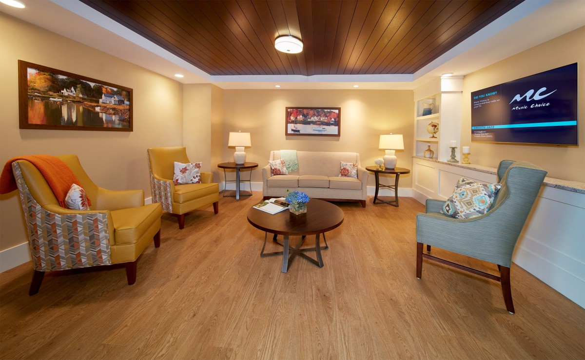 A cozy living room with comfortable seating and warm lighting.