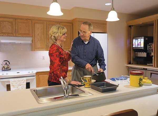 A couple preparing a meal together in the kitchen.