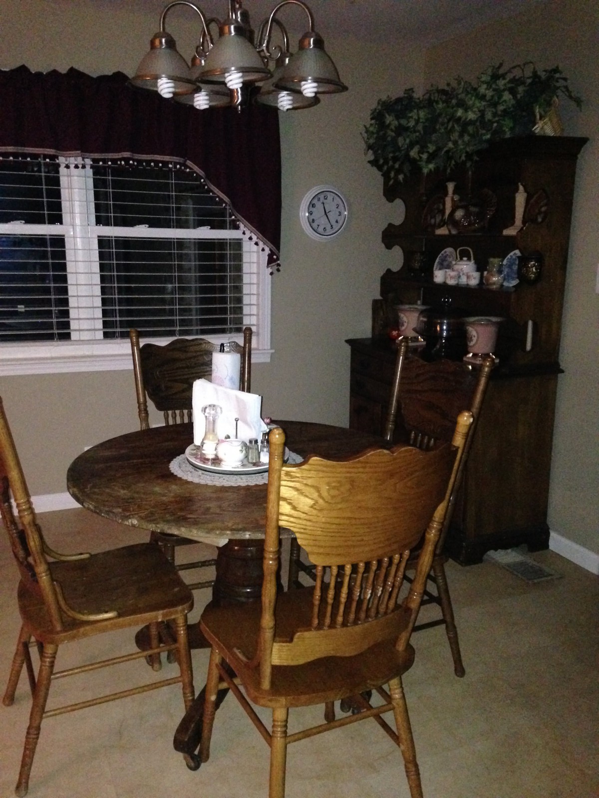A cozy dining room with a wooden table and chairs near a window.