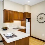 Modern kitchen interior with wood cabinets and a compact design.