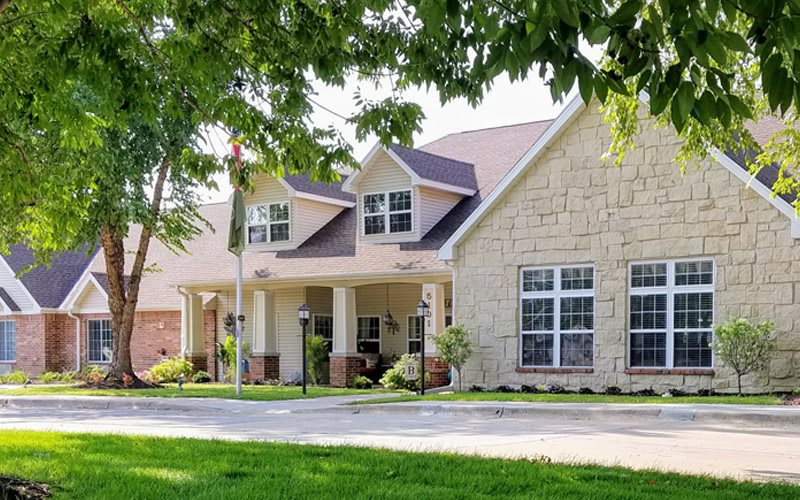 A suburban house with a stone facade and well-maintained front yard.