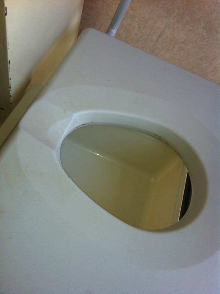 A close-up view of a white bidet in a bathroom.