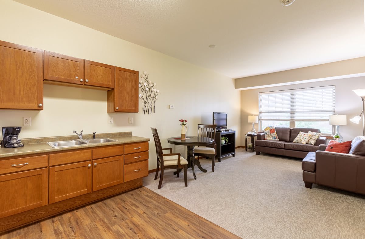 Cozy studio apartment with a kitchenette, dining area, and living space.