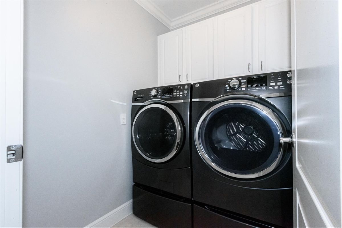 Modern laundry room with black washer and dryer.