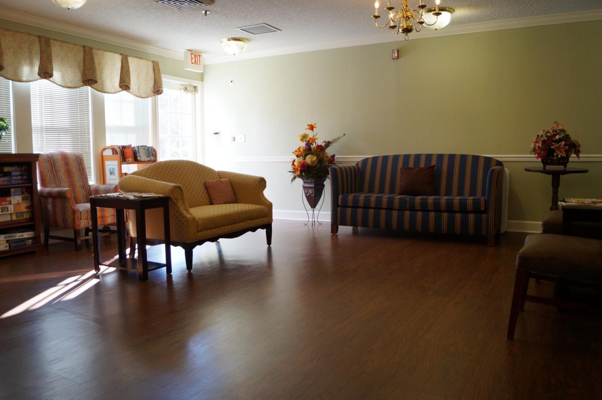 A cozy living room with elegant furniture and wooden flooring.