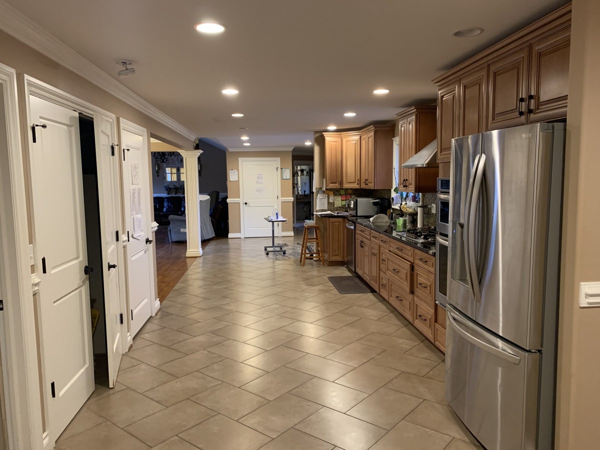 A spacious modern kitchen with wooden cabinets and stainless steel appliances.