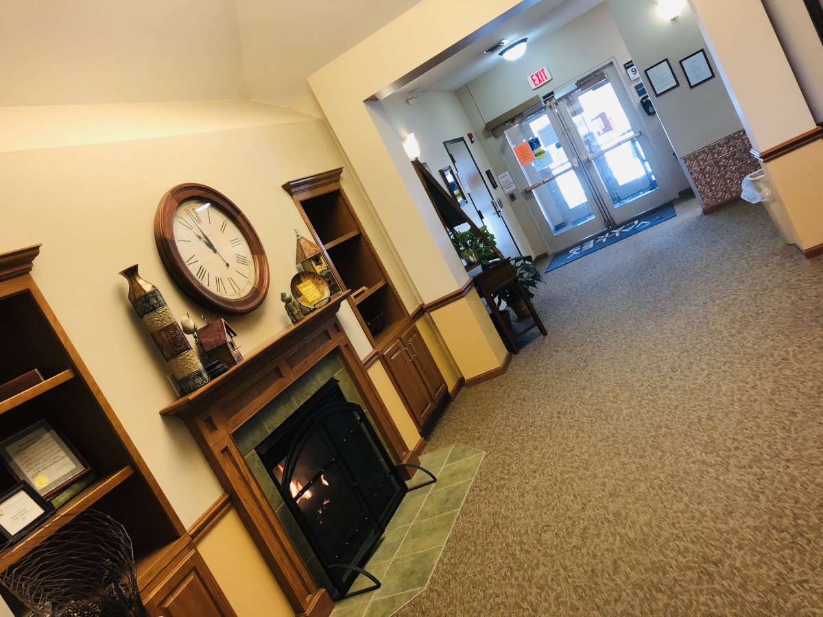 A cozy lobby area with a fireplace and decorative elements.