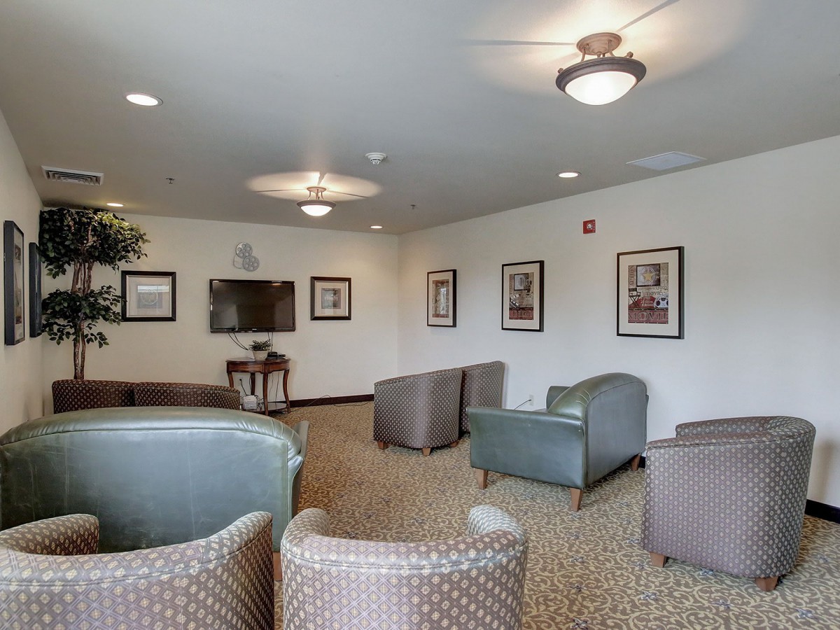 A comfortable lounge area with chairs and a television.