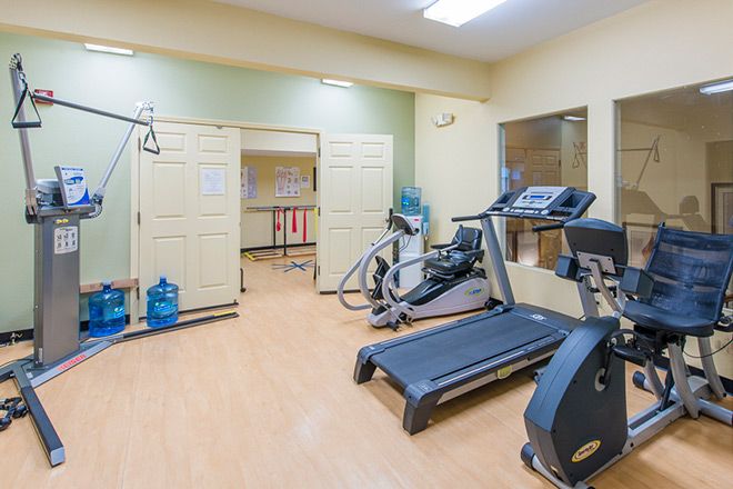 A small gym with treadmills and exercise equipment.