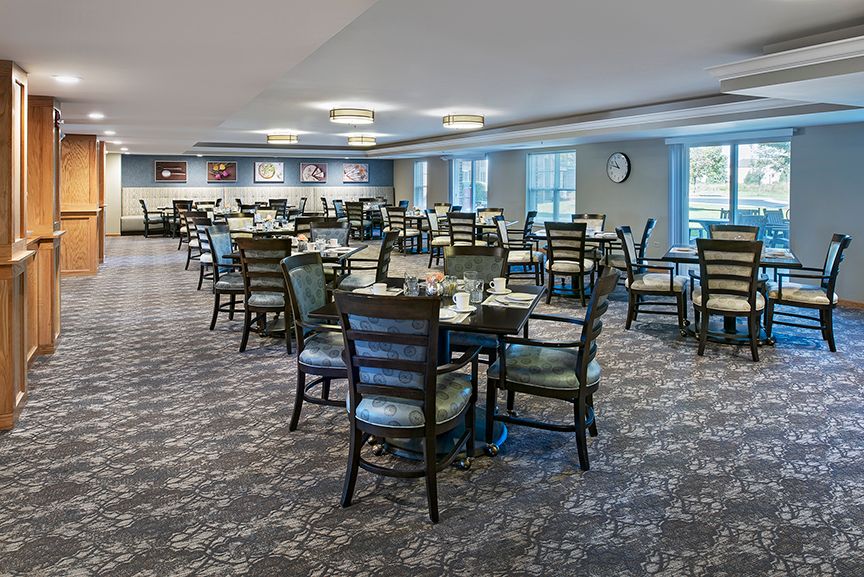 Spacious dining room with neatly arranged tables and chairs.