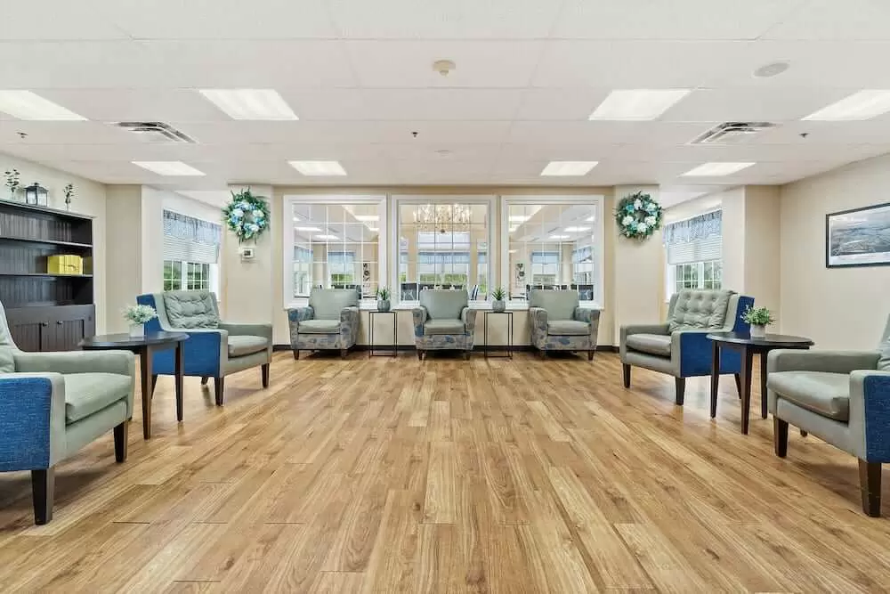 A modern waiting room with comfortable seating and wooden flooring.