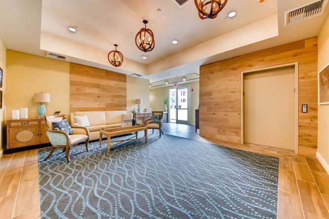 A modern lobby with comfortable seating and decorative lighting.