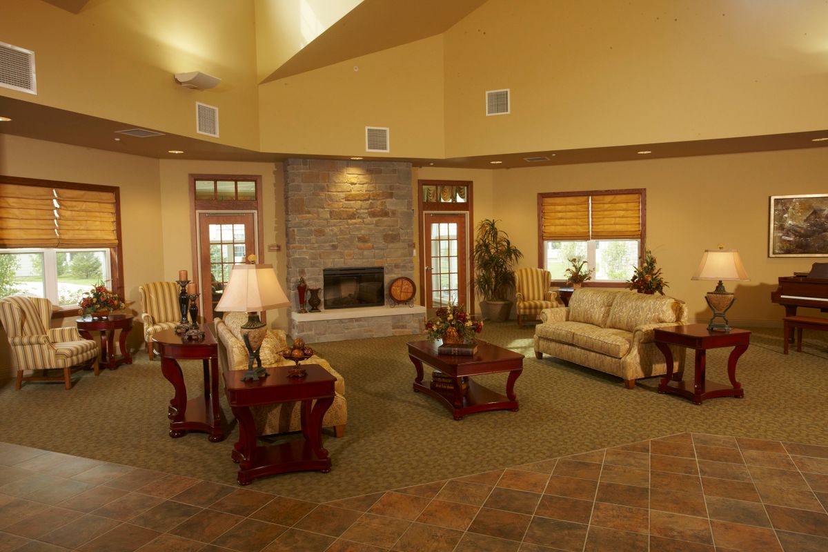 A cozy living room with a fireplace and elegant furnishings.
