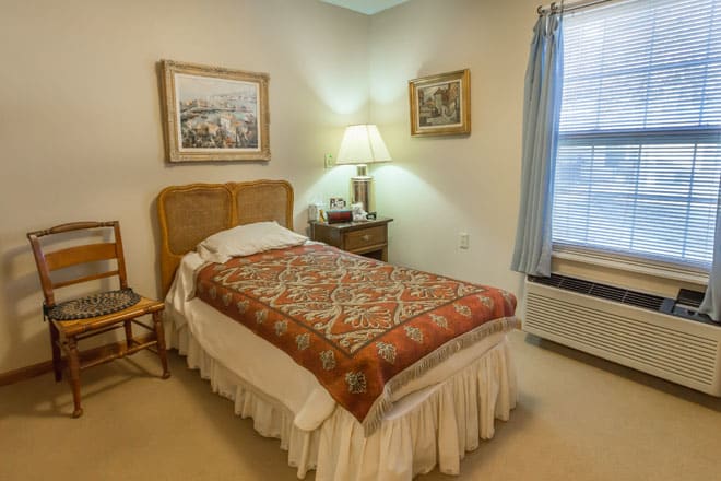 A cozy bedroom with a single bed and traditional decor.