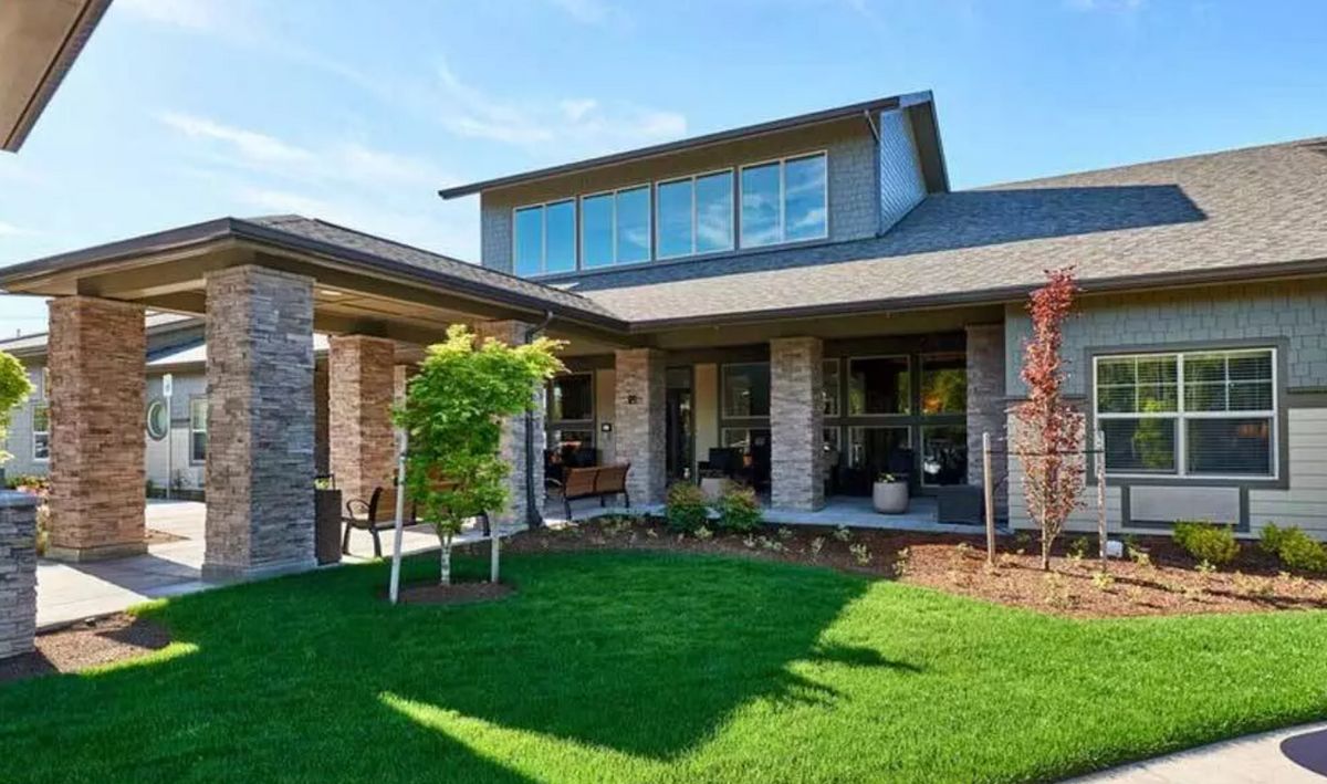 A modern house with a well-maintained lawn and garden.