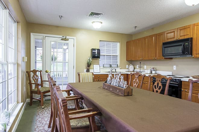 A cozy kitchen and dining area with wooden furniture and cabinets.