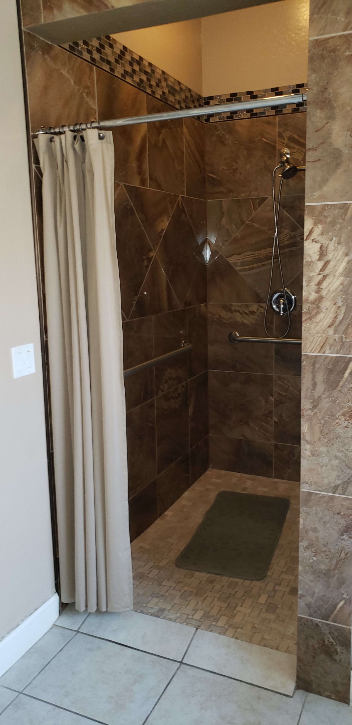 A modern bathroom shower with elegant tile work.