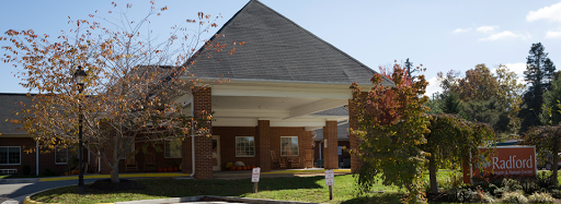 A modern brick building with a sloped roof and welcoming entrance.