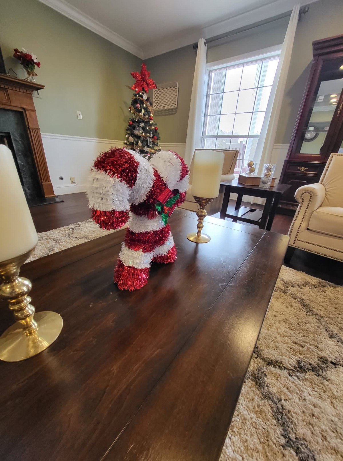 Festive candy cane decoration in a holiday-themed living room.