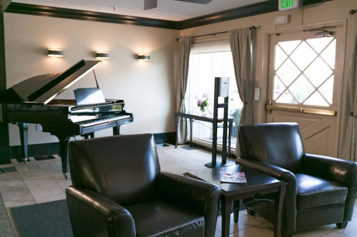 A sophisticated lounge area featuring a piano and comfortable seating, perfect for relaxation.