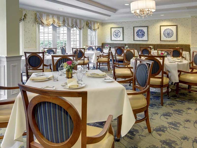 An elegant dining room with neatly arranged tables and chairs, ready for guests.