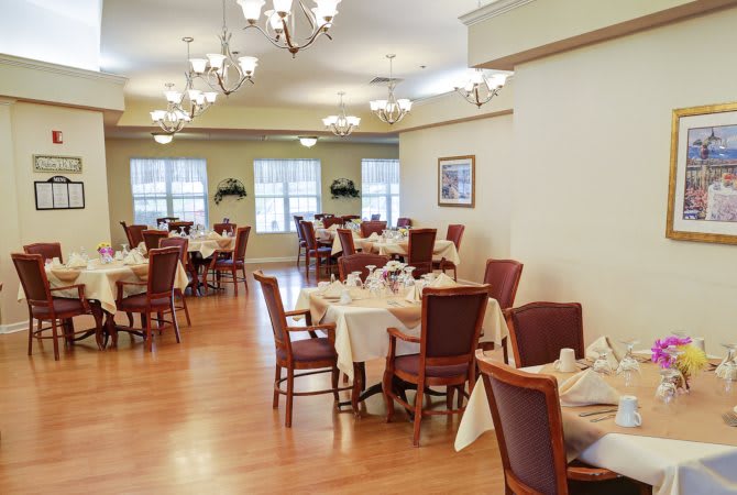 An elegantly decorated dining room with neatly arranged tables and chairs.