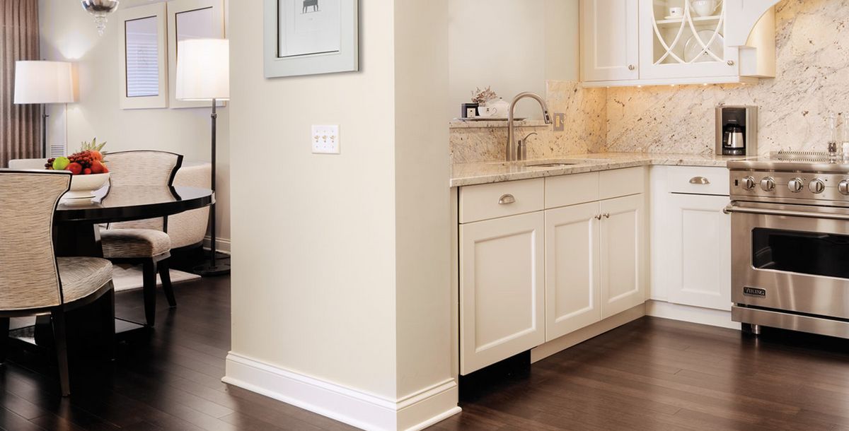 A modern kitchen interior featuring a sink and cabinets with a light-colored countertop.