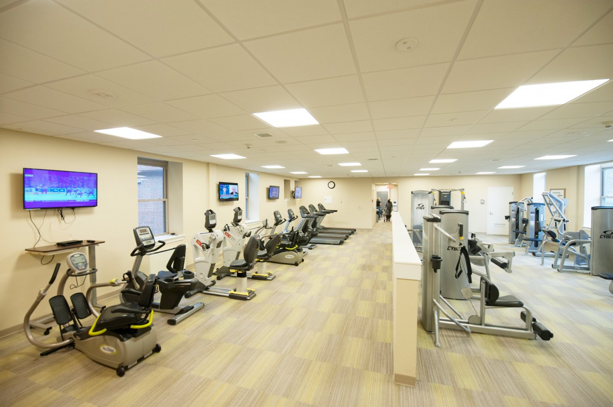 A spacious gym with a variety of exercise equipment including treadmills and stationary bikes.