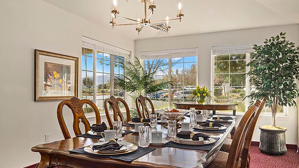 A beautifully set dining room table with elegant decor and abundant natural light.