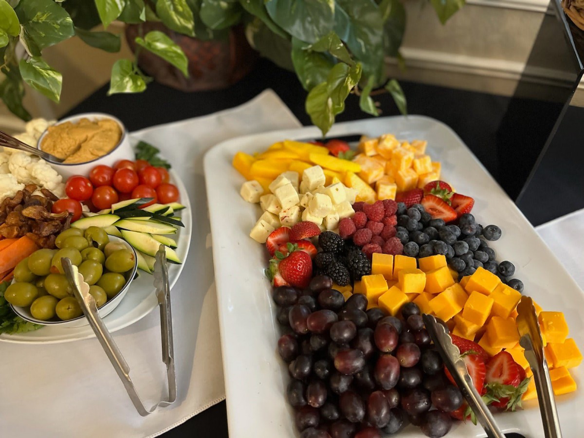 A colorful spread featuring a variety of fruits, cheeses, and vegetables on a serving platter.