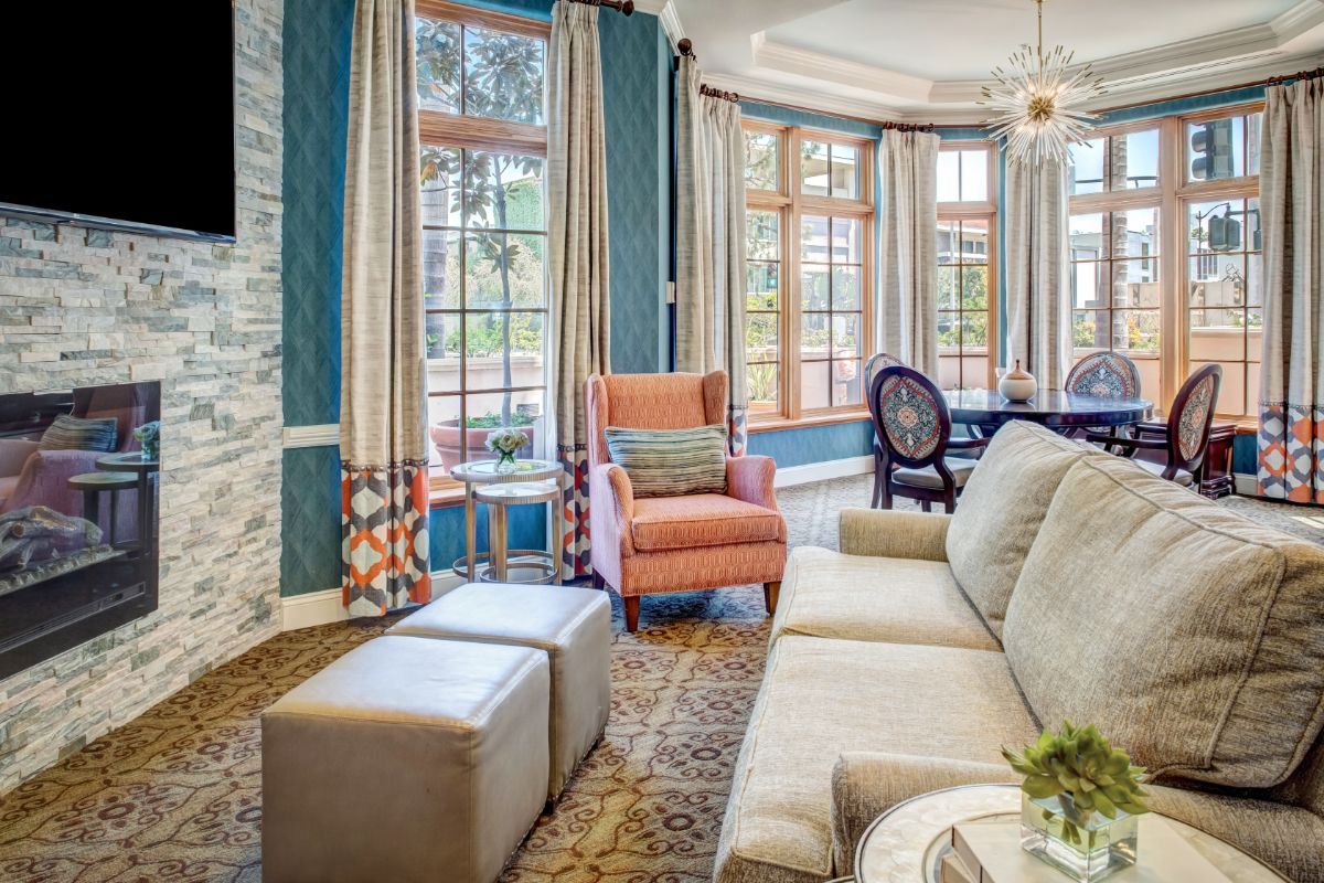 A stylish living room with modern decor featuring a comfortable armchair and large windows.