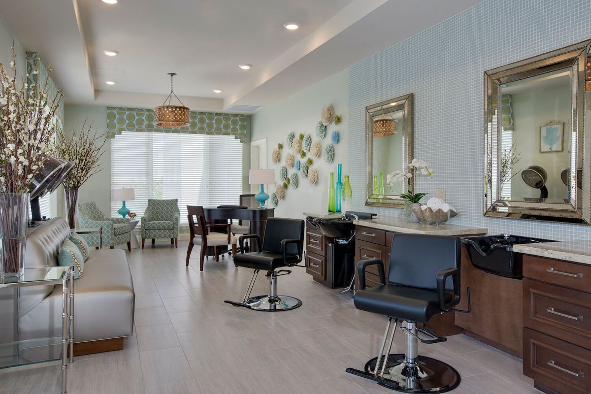 A modern hair salon interior with stylish decor and comfortable seating.