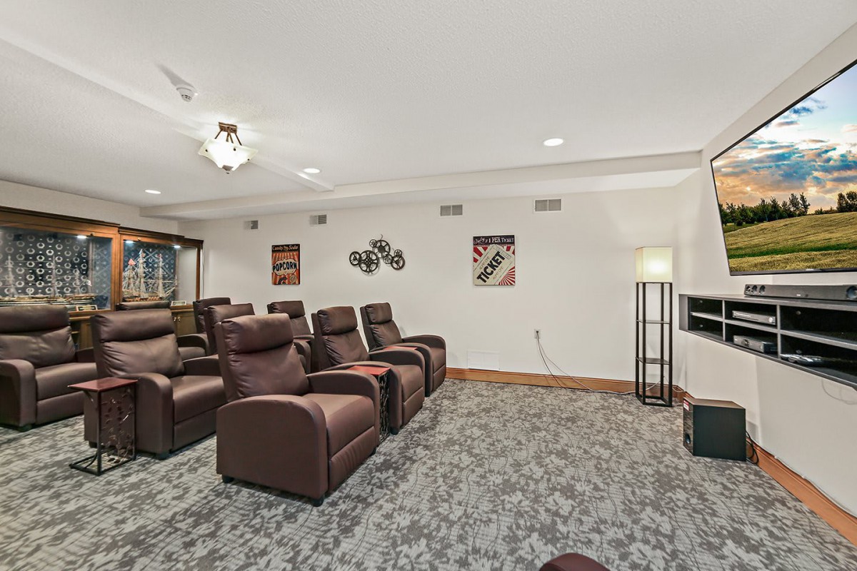 A cozy home theater featuring comfortable recliner seating and modern decor.