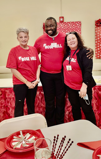 A group of volunteers proudly posing together at a community event.