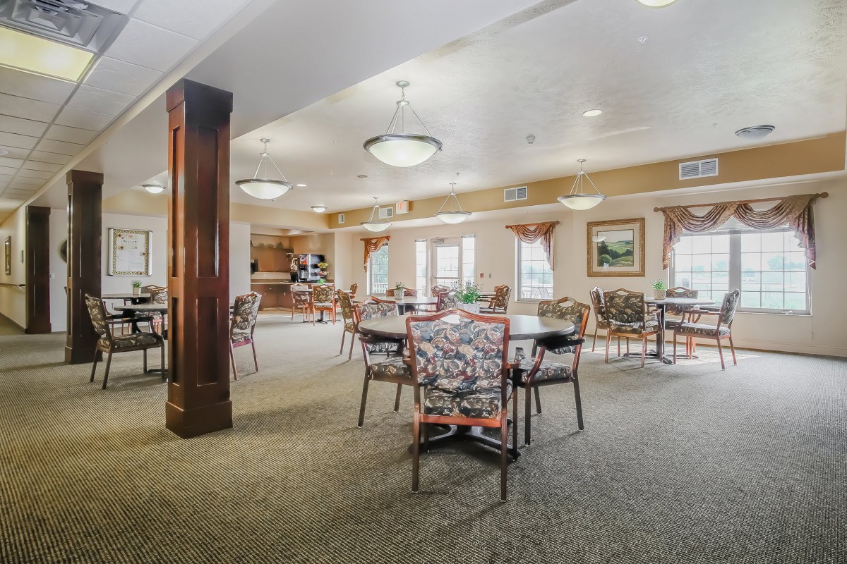 A spacious dining area with tables, chairs, and ambient lighting.