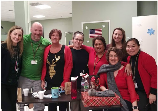 A cheerful group celebrating the holiday season with festive attire and smiles.
