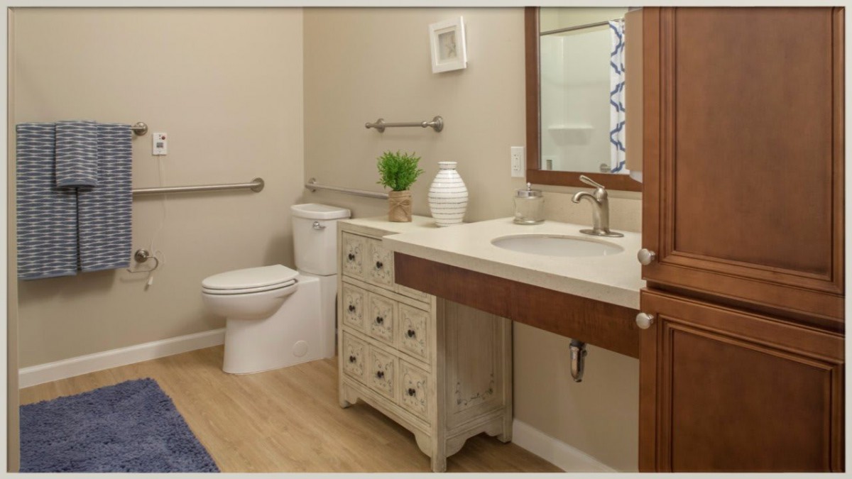 A well-organized bathroom with a vanity, mirror, and toilet.