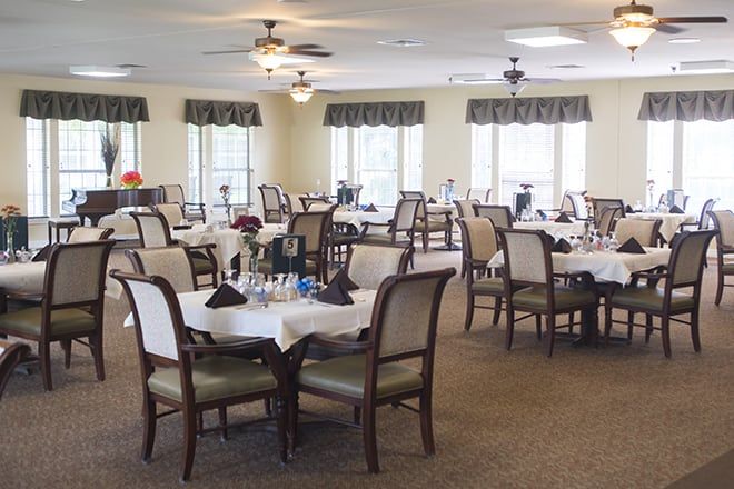 A well-decorated dining room with multiple tables and chairs.