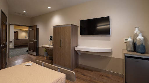 A modern and clean hospital room equipped with essential amenities.