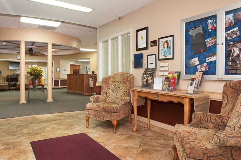 A cozy waiting room with comfortable chairs and various decorations on the walls.