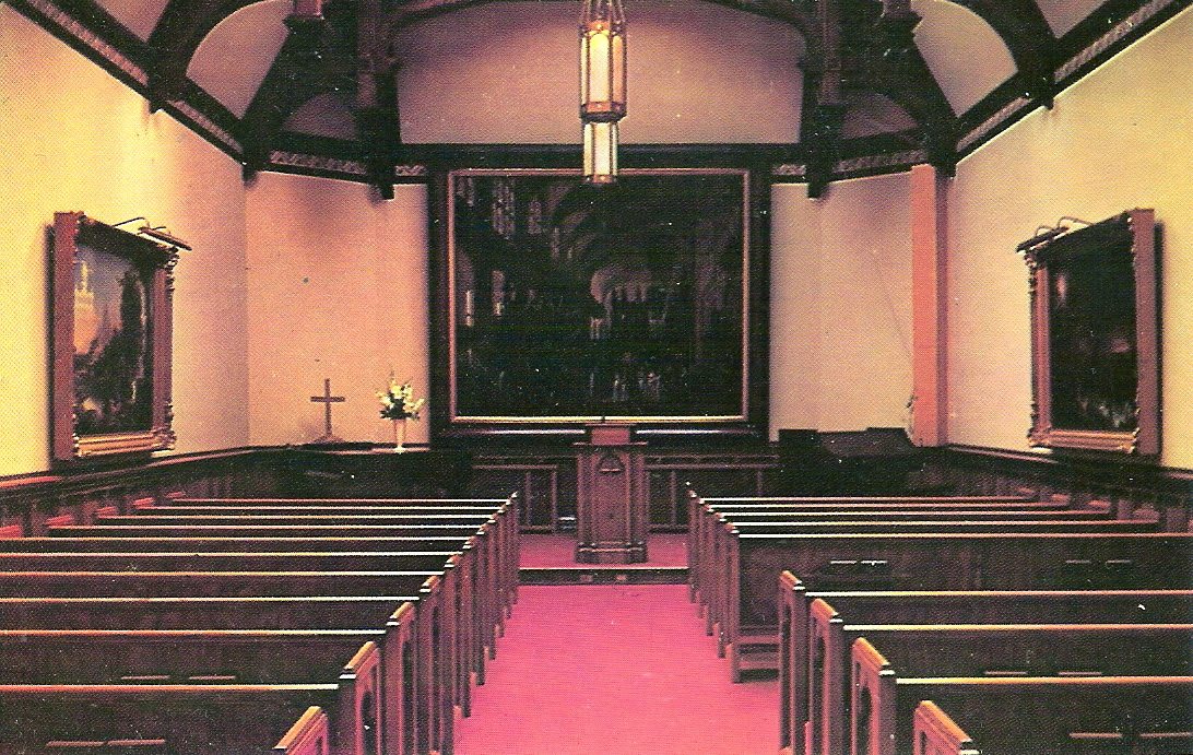 Interior view of a church with rows of pews and a pulpit at the front.