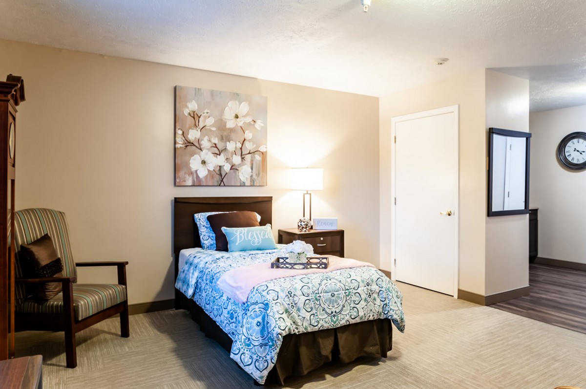 A cozy bedroom with a single bed and decorative wall art.