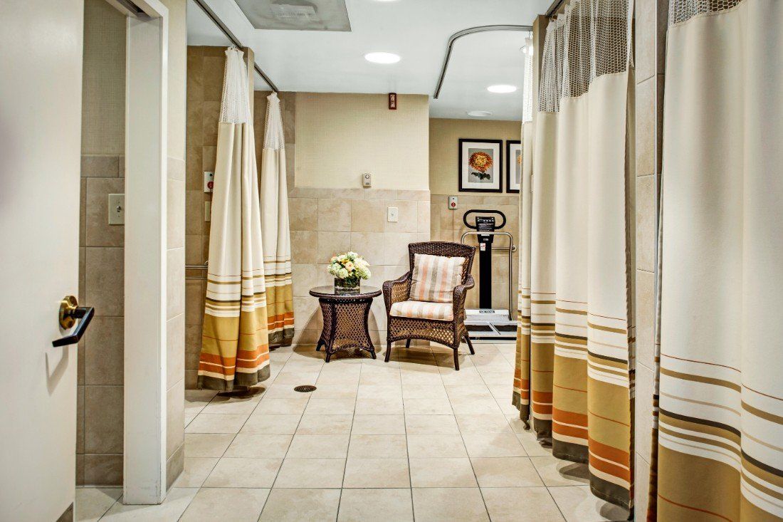 A serene spa interior featuring cozy seating and soft curtains for a relaxing ambiance.