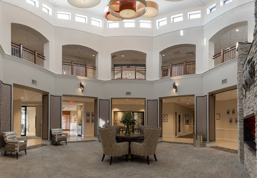 A spacious modern lobby featuring elegant furnishings and a high ceiling.