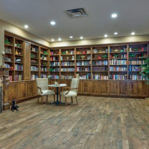A cozy library with extensive bookshelves and a reading area.