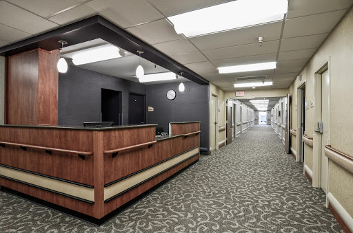 A view of the reception area in a healthcare facility, with a corridor extending into the background.